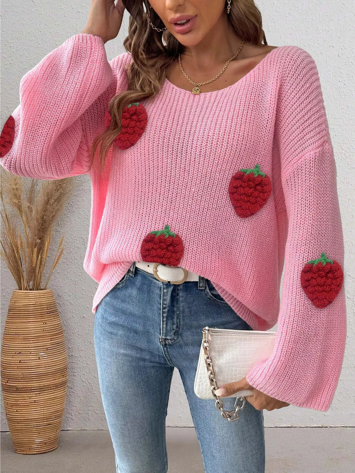 Oversized strawberry applique sweater in soft knit, featuring colorful strawberry patches on a trendy casual sweater by Trendsi.