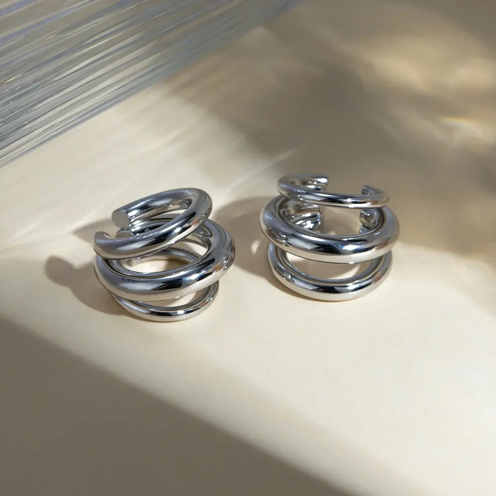 Silver stainless steel layered cuff earrings featuring multiple overlapping bands, stylish and modern jewelry from Plush Fashion Hub