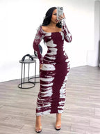 Colorful tie-dye long sleeve maxi dress by Shopimist featuring vibrant patterns and a flowing silhouette.