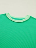 Women's ribbed twist hem short sleeve T-shirt with contrast stitching, stylish and comfortable from Trendsi.