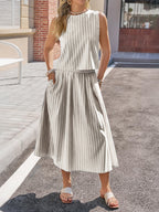 Women's striped sleeveless top and midi skirt two-piece set by Trendsi, featuring a stylish and comfortable summer outfit.