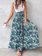 Printed wide-leg pants from Shopimist featuring a relaxed fit and vibrant floral pattern, shown on a model.