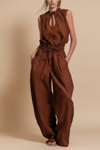Women's sleeveless high-waist wide-leg pleated jumpsuit by Plush Fashion Hub, featuring a casualwear style with flowing fabric.