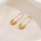 Safety pin pearl accent earrings featuring small pearls on minimalist safety pin design, stylish jewelry by Shopimist.