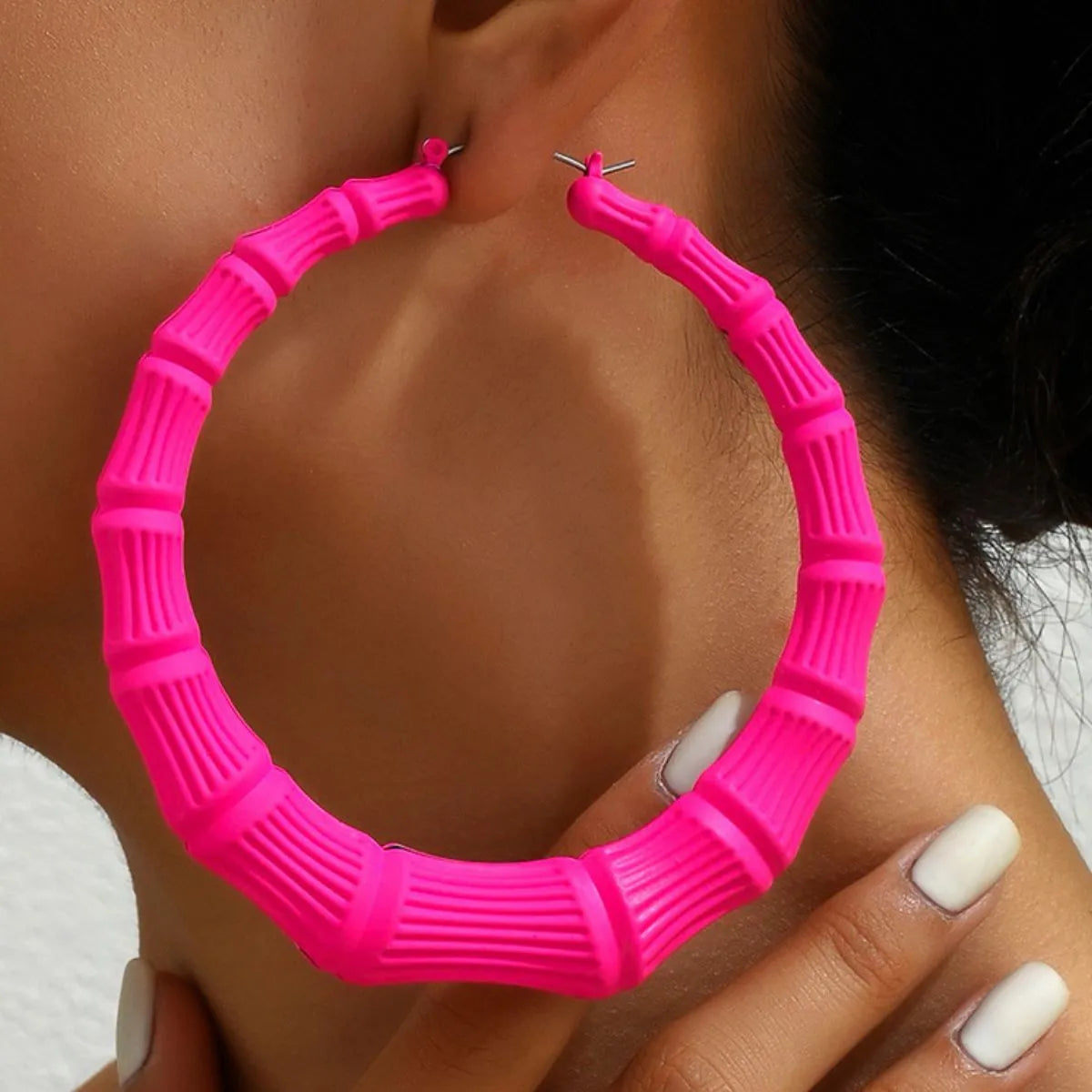 Stainless steel textured hoop earrings from Shopimist, showcasing their polished, detailed surface and classic hoop design.