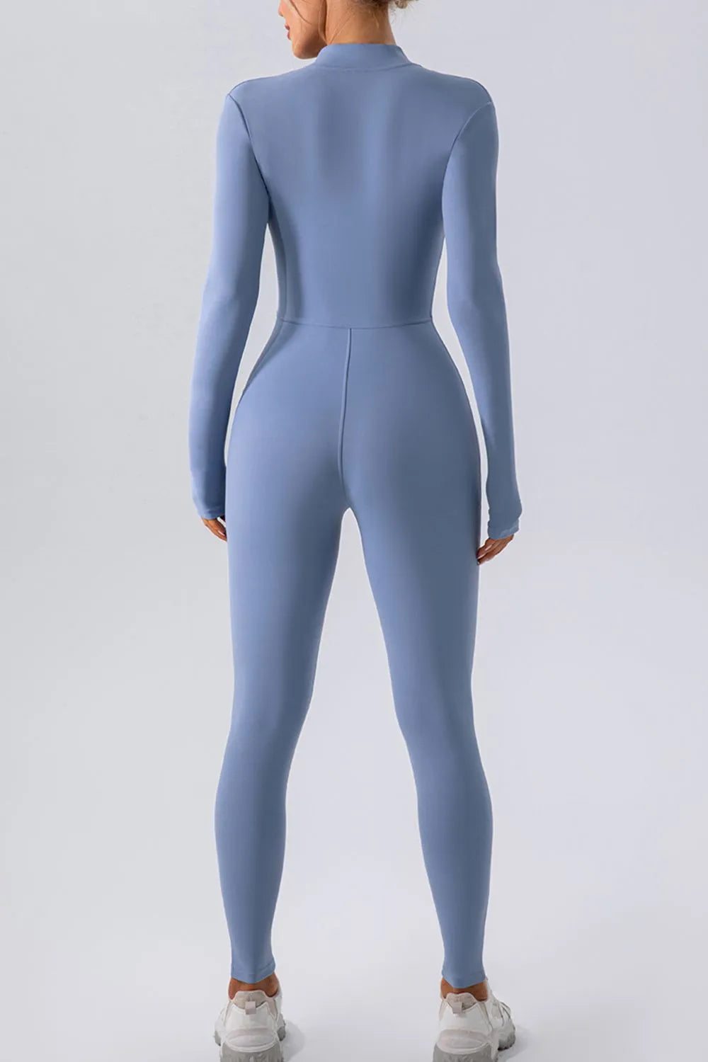 Trendsi half zip mock neck active jumpsuit in black, featuring a fitted design and athletic style for workout or casual wear.