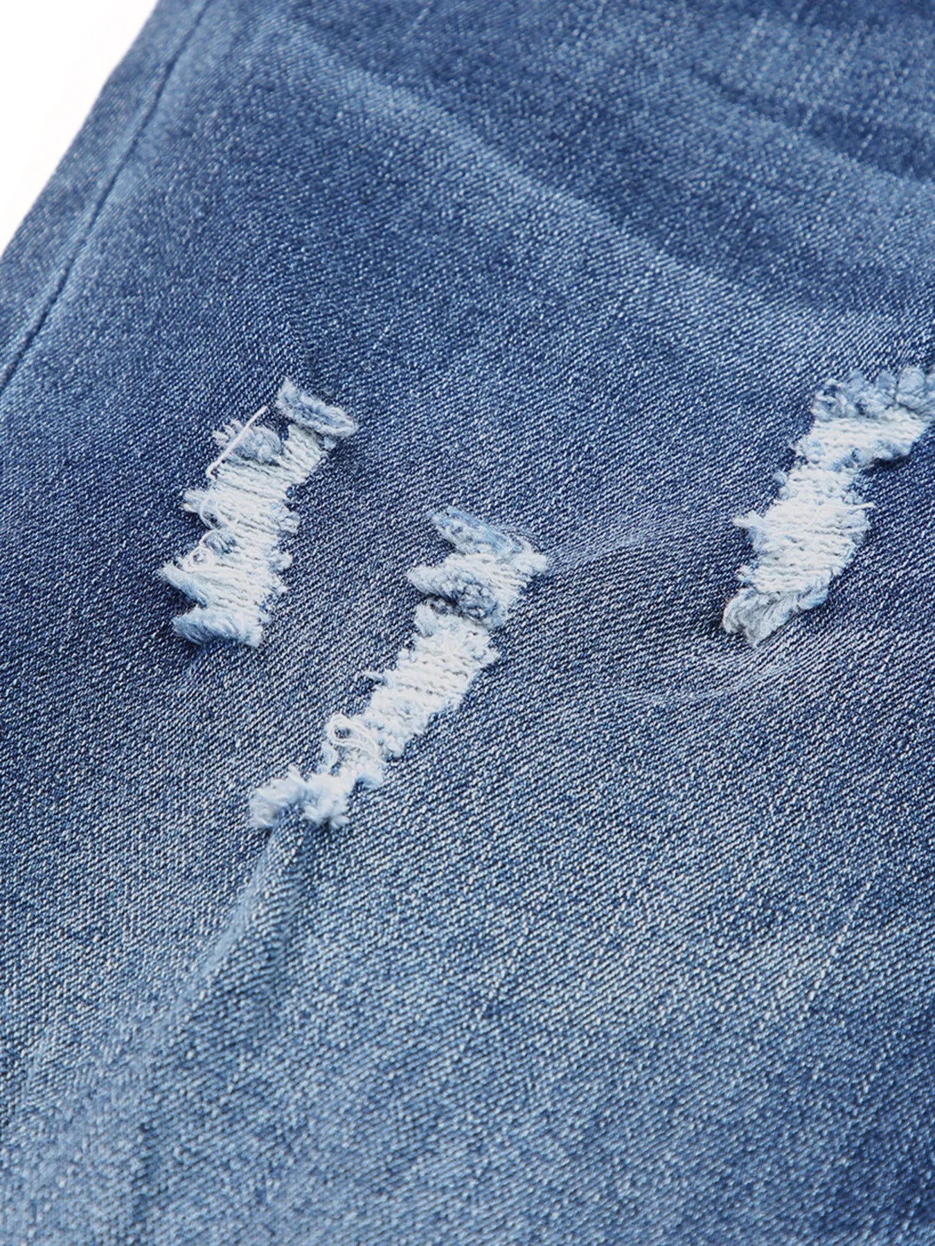 High waist distressed straight leg jeans by Trendsi, showing a close-up of the ripped denim fabric and classic five-pocket style.