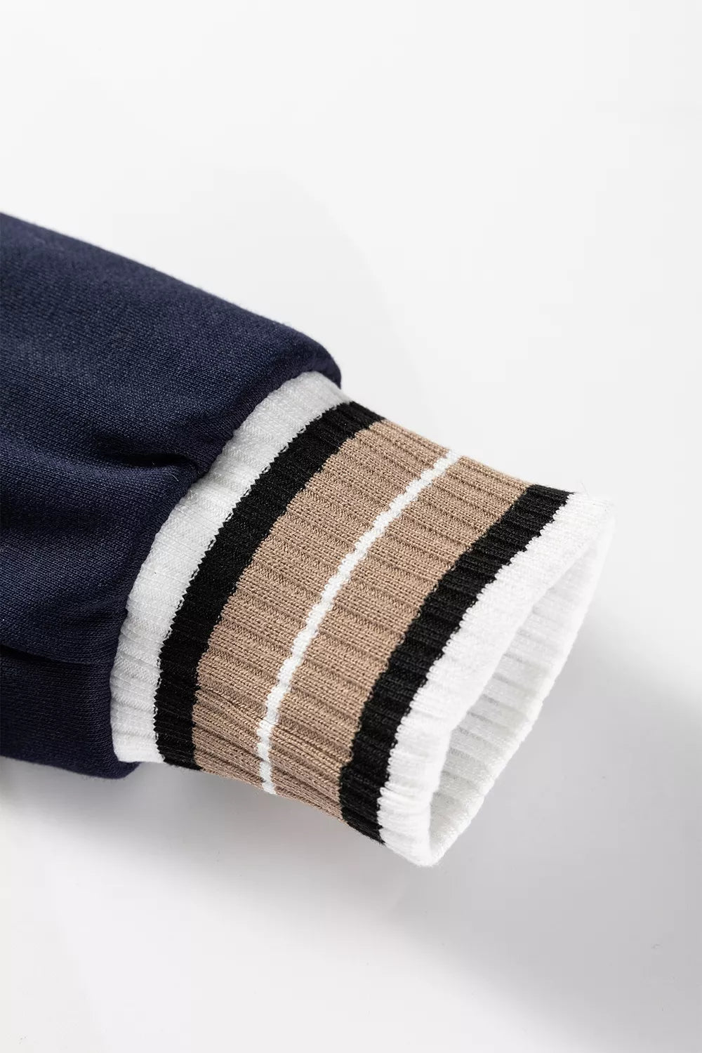 Contrast striped trim V-neck sweatshirt by Trendsi featuring a cozy fit and stylish design, shown in a front view.