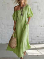 Elegant one-shoulder puff sleeve maxi dress by Trendsi featuring flowing fabric and a sophisticated silhouette.