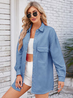 VYSN denim shacket with dropped shoulders and pocketed snap-down front, featuring a casual, relaxed fit and stylish design.
