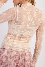 Sheer floral mesh long sleeve top with ruched details, stylish and lightweight, from Trendsi's collection.