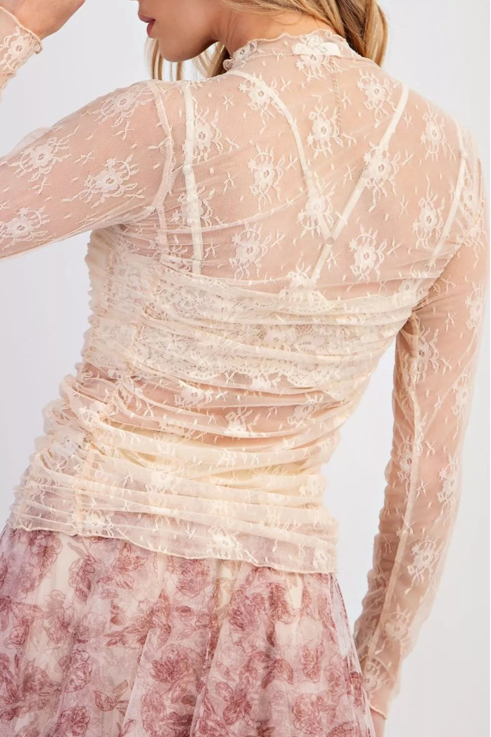 Sheer floral mesh long sleeve top with ruched details, stylish and lightweight, from Trendsi's collection.
