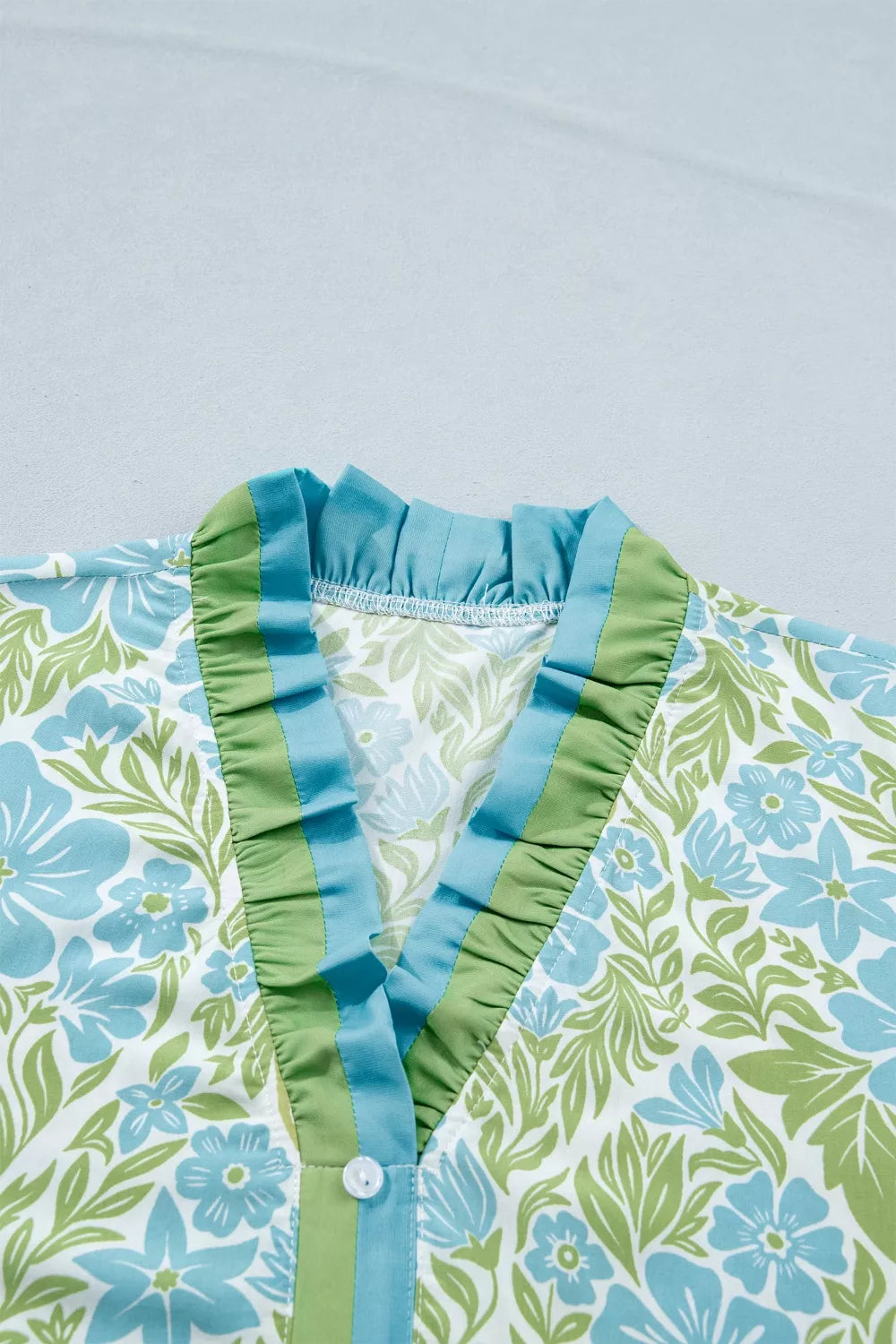 Floral print ruffle hem button-up mini dress from Plush Fashion Hub, showing the lightweight fabric and vibrant floral pattern.