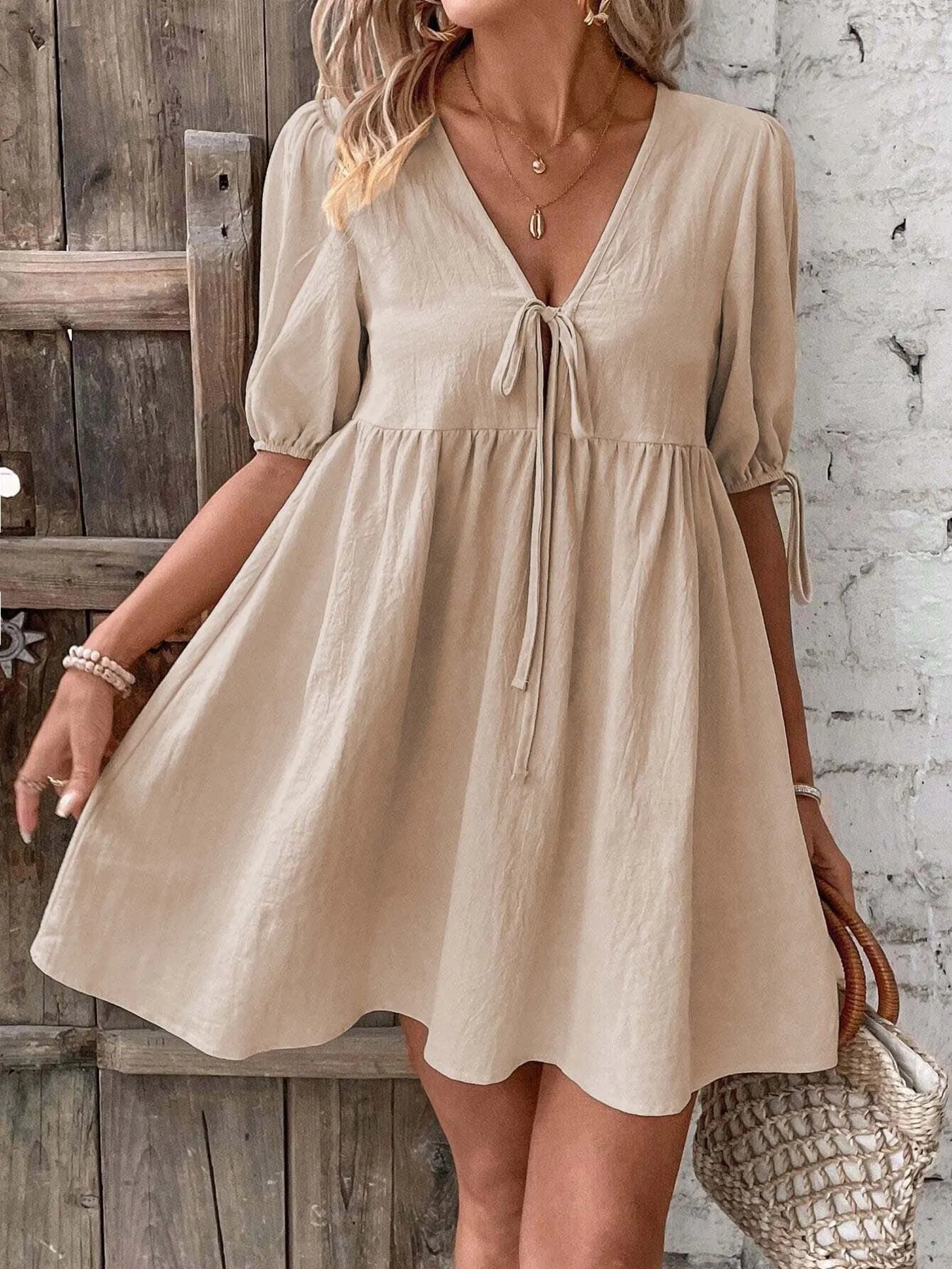 Light blue cotton V-neck tie-front mini dress with puff sleeves, featuring a stylish and feminine design from Trendsi.
