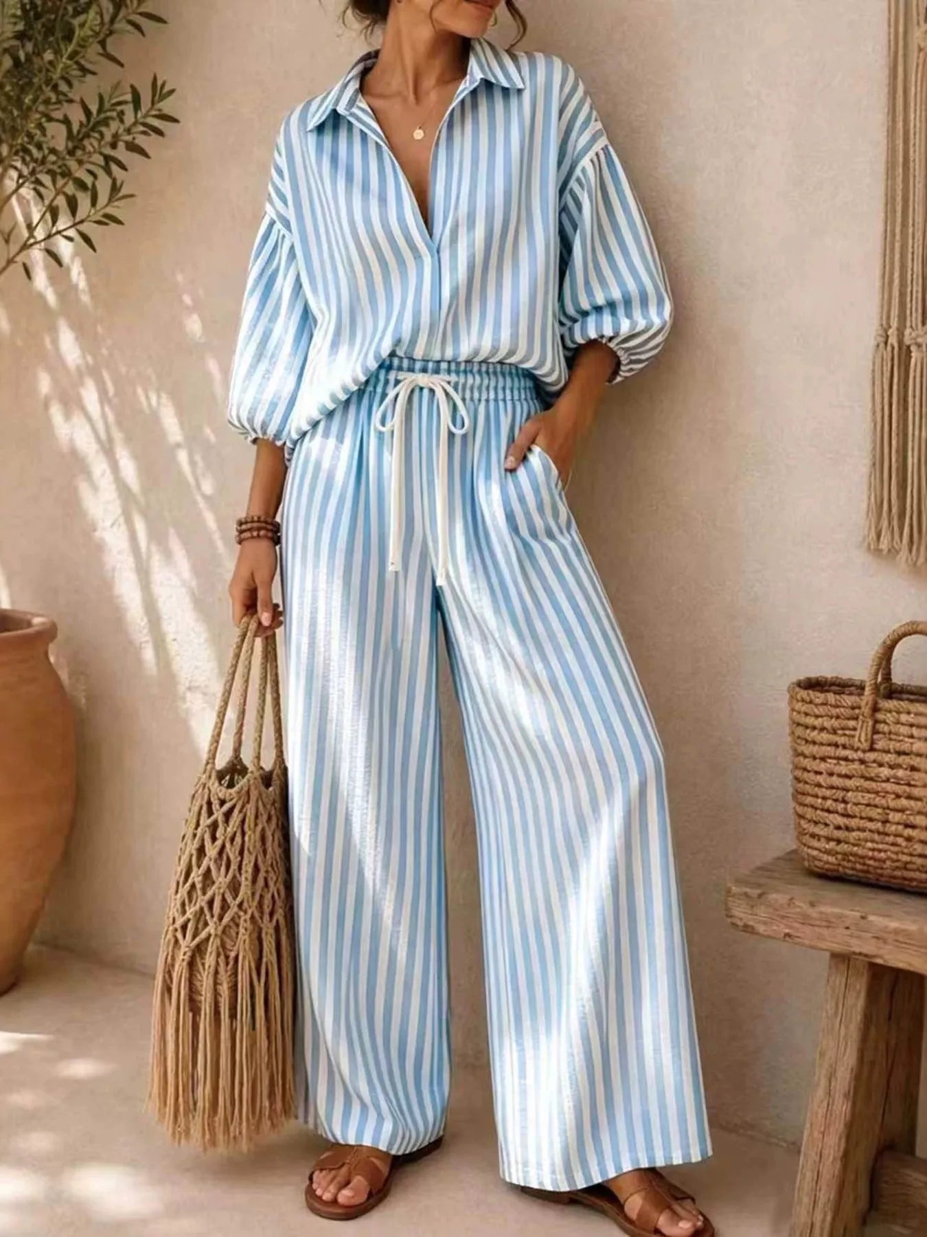 Plus size striped puff sleeve shirt and wide-leg drawstring pants set from Trendsi, featuring a stylish coordinated pants and top ensemble.