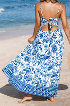 Floral print twisted front backless maxi dress by Trendsi, featuring cutout back and flowing silhouette for elegant summer style.