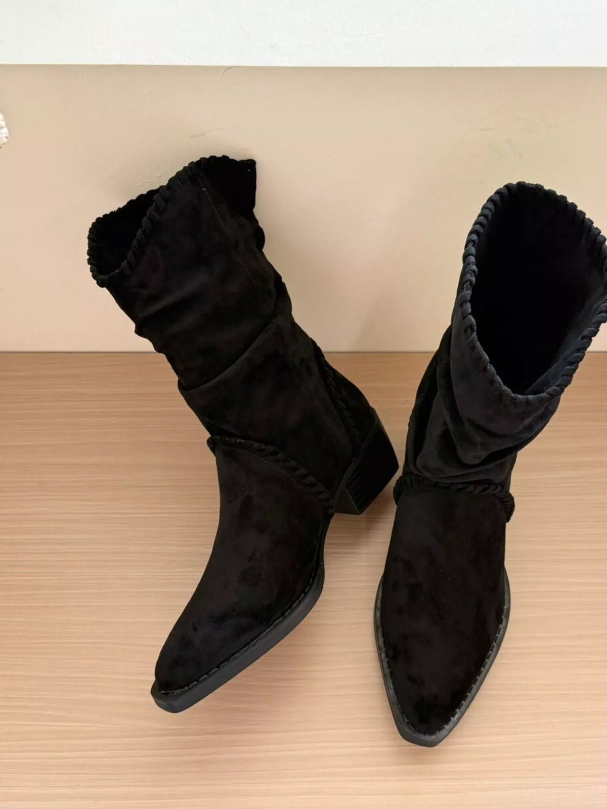 Point toe block heel boots in black leather from Trendsi, stylish footwear with a sleek design and sturdy block heel.