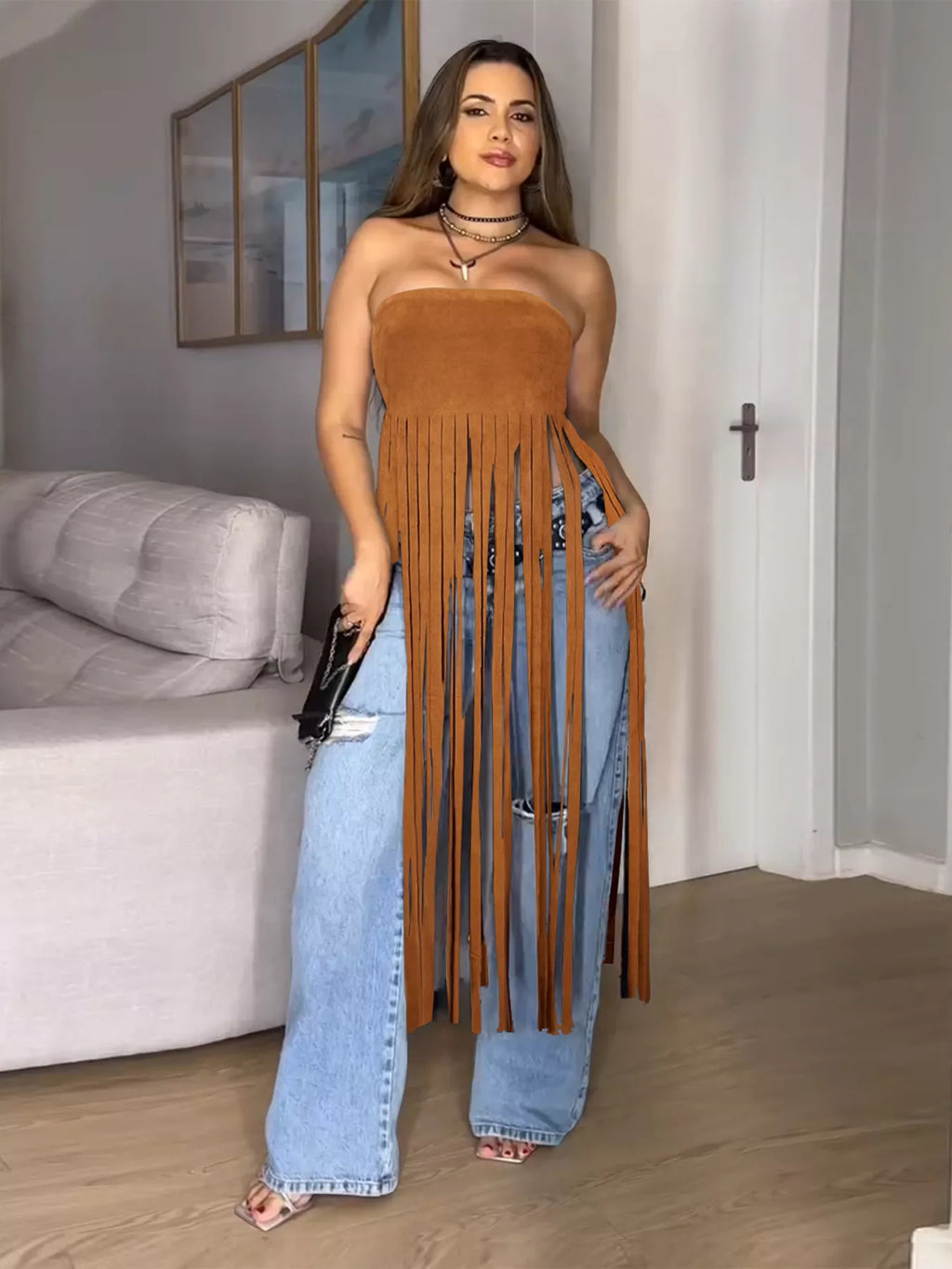 Close-up of a trendy fringe trim tube top with ring details, showcasing the stylish design and fabric texture.
