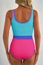 Threaded Pear Rory patchwork one-piece swimsuit with colorful quilted design, stretchy fabric, and adjustable straps.
