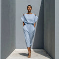 Women's off-shoulder batwing sleeve maxi dress by FitiqueFit with elastic waist and flowy silhouette, shown on model.