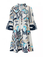 Bohemian print tiered mini dress by Shopimist featuring colorful patterns and a flowy, layered design perfect for summer wear.