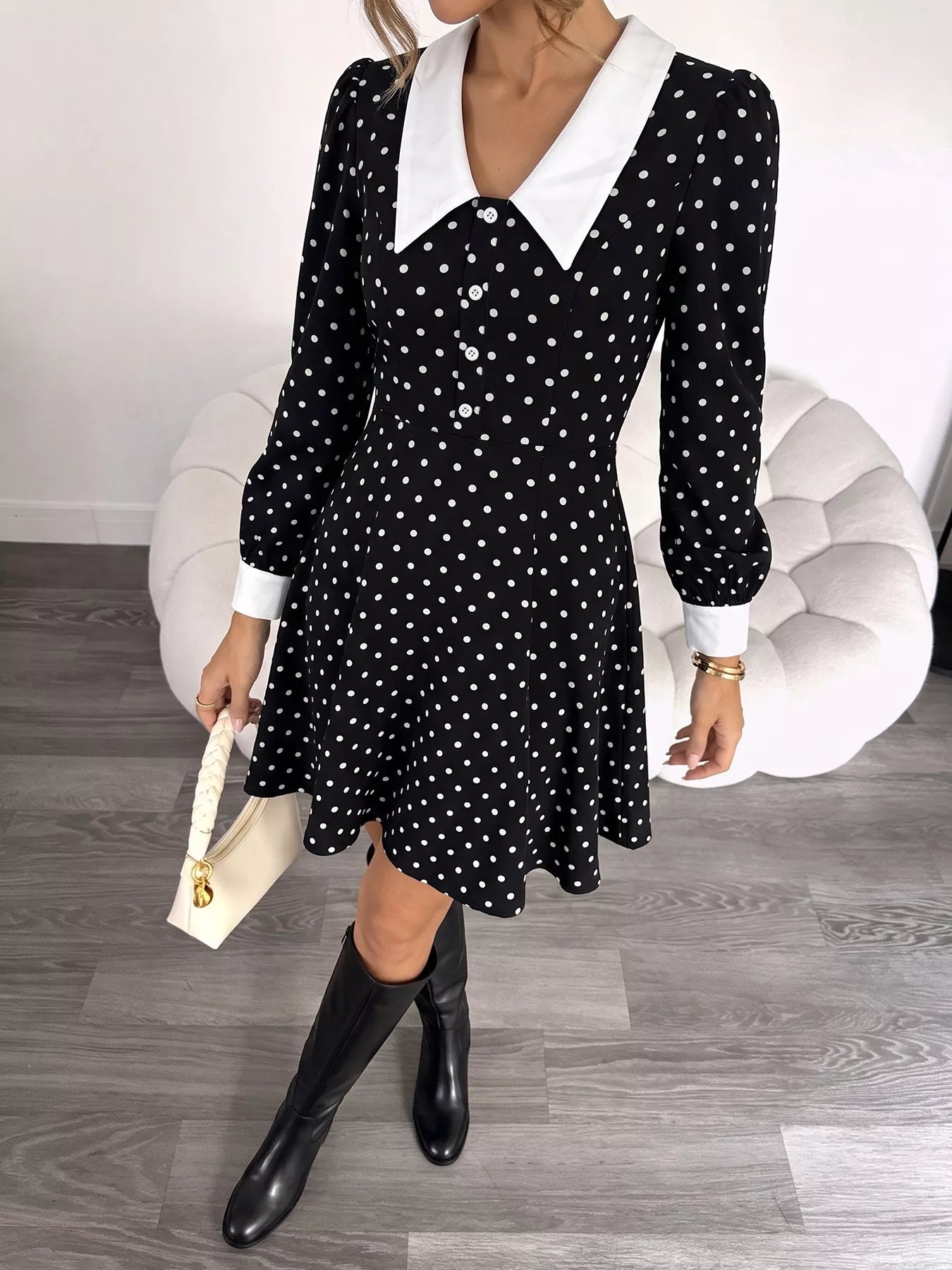Polka dot Peter Pan collar dress by Plush Fashion Hub featuring a classic style and playful pattern, shown on a hanger.