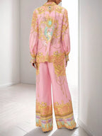 Women's printed lantern sleeve top and pants lounge set by Trendsi, featuring a comfortable, stylish matching clothing set.
