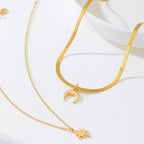 Gold-plated moon and star necklace from Shopimist, featuring a delicate chain with celestial pendant designs.