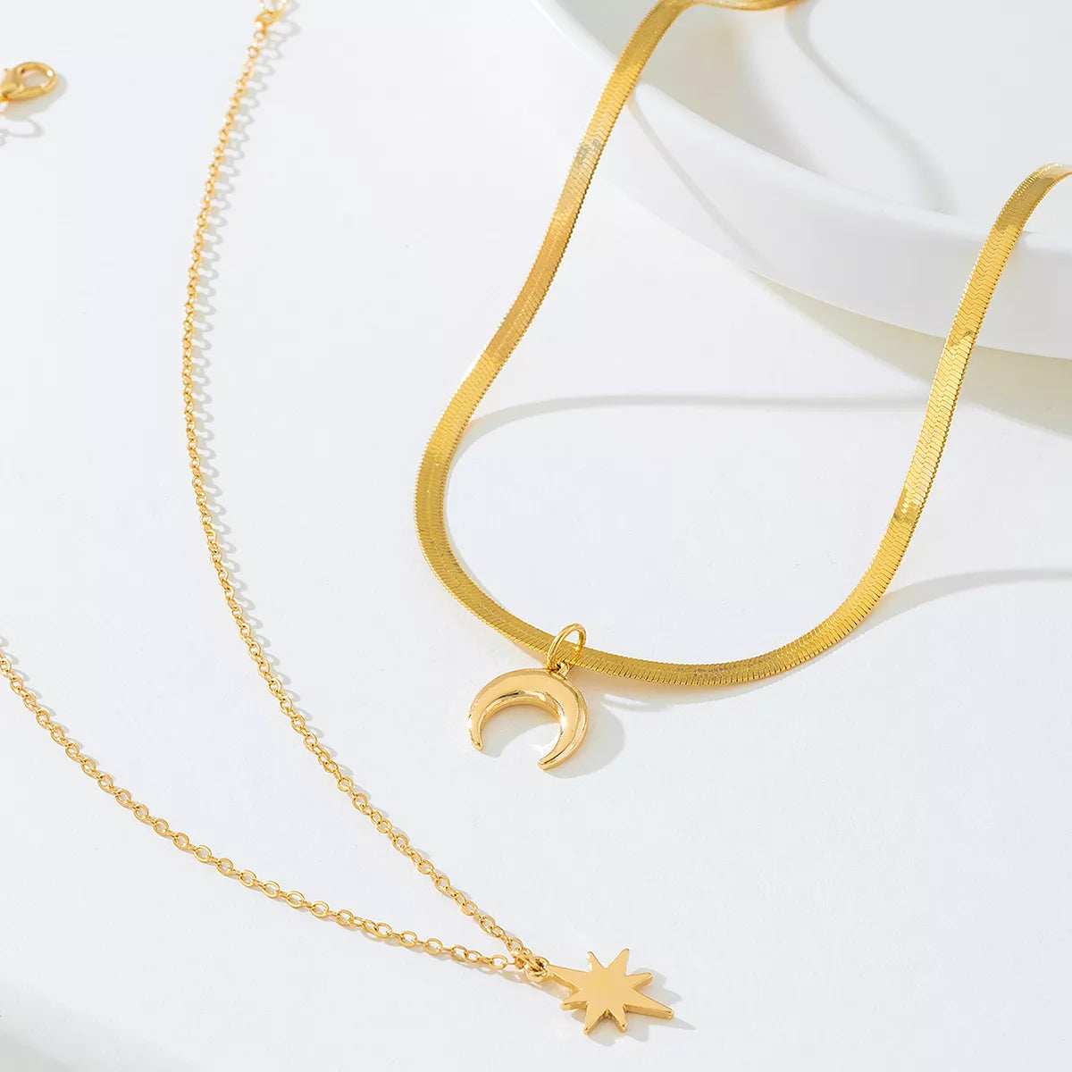 Gold-plated moon and star necklace from Shopimist, featuring a delicate chain with celestial pendant designs.