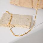 18K gold-plated cross necklace with delicate chain, showcasing a stylish religious pendant on a neutral background.