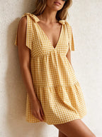 Gingham tie-shoulder mini dress by Plush Fashion Hub featuring a playful skirt with a fitted waist and adjustable shoulder ties.
