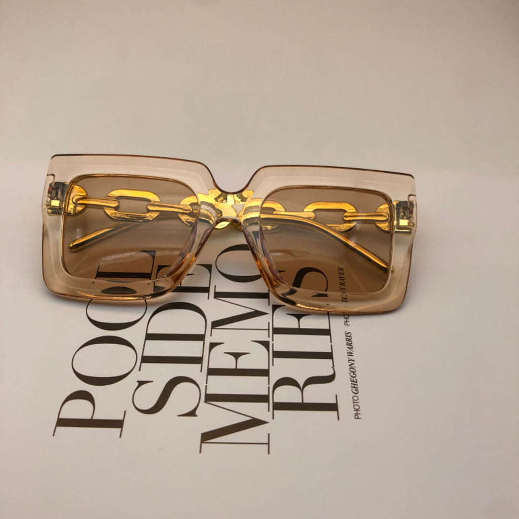 Square chain sunglasses for women by Plush Fashion Hub with black frames and stylish arm detailing, perfect for sunny days
