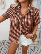 Women's lightweight plaid button-up short sleeve shirt by Trendsi, featuring a stylish checkered pattern and classic collar.