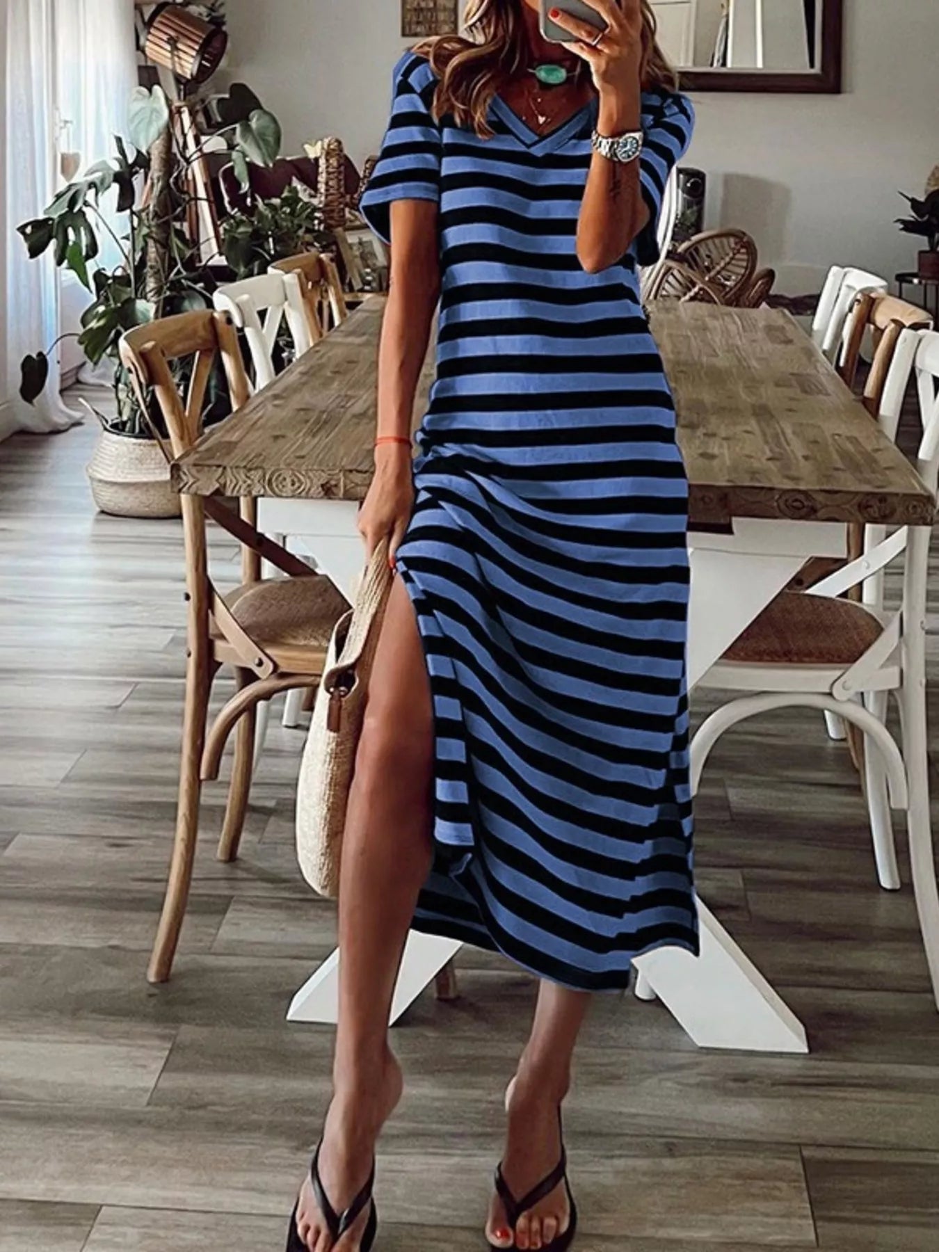 Plus size striped V-neck midi dress with side slit, stylish and comfortable, by Trendsi, perfect for casual or dressy occasions.