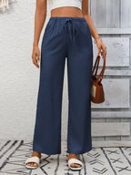 Women's high-waisted wide-leg drawstring pants in soft breathable viscose, shown in a relaxed fit with adjustable waist.