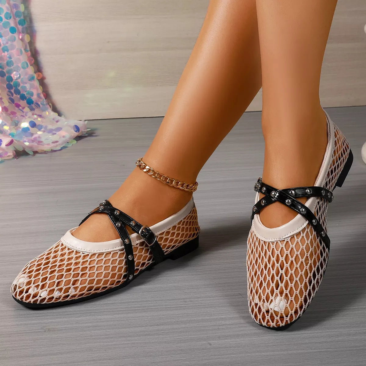 Studded crisscross mesh slip-on shoes by Trendsi featuring a stylish design with mesh and metal stud accents.