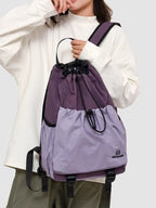 Lightweight nylon drawstring backpack for women, minimalist travel bag with simple design and adjustable straps.
