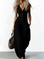 V-neck button-down wide-leg jumpsuit by Trendsi featuring a stylish, flowy silhouette and elegant design in a natural fabric.