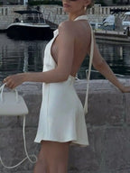 Shopimist halter neck mini dress featuring a fitted silhouette and stylish design, shown on a model.