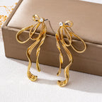 18K gold-plated bow earrings with delicate design, featuring shiny gold finish, perfect for elegant jewelry accessories.