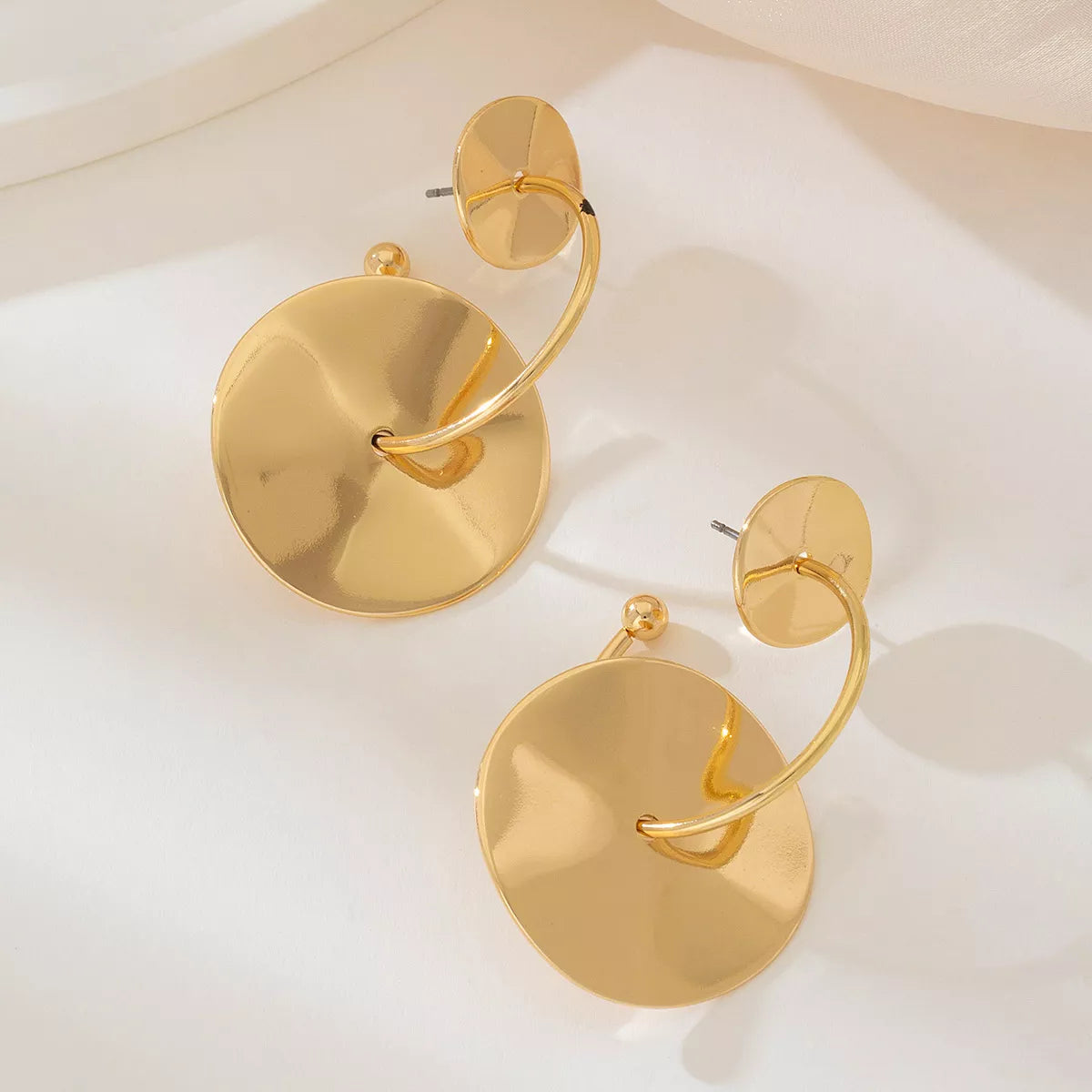 18K gold-plated geometric circle drop earrings featuring modern design with sleek, shiny finish.