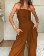 Backless loose tube-top jumpsuit with wide-leg long pants, stylish women's overalls in beige from Plush Fashion Hub.