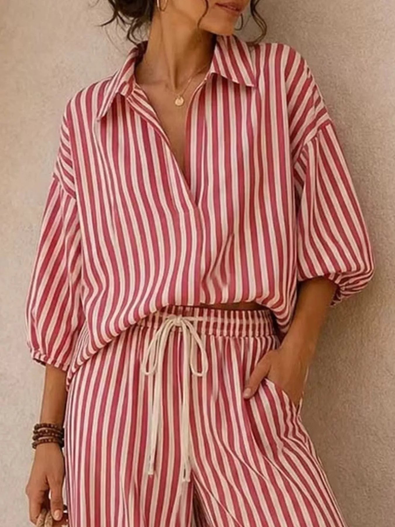 Plus size striped puff sleeve shirt and wide-leg drawstring pants set by Trendsi, featuring bold stripes and relaxed fit.
