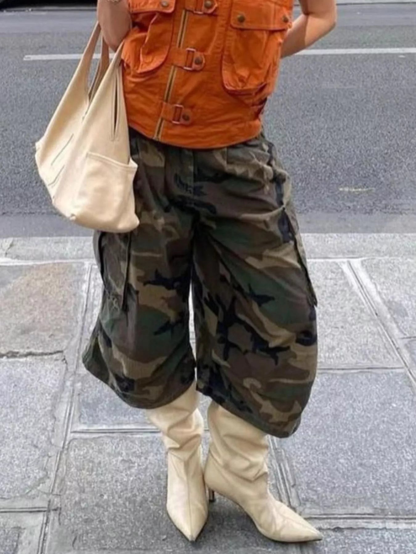 Camouflage cargo cropped pants by Plush Fashion Hub featuring multiple pockets and a relaxed fit, styled for casual wear.