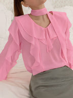 Elegant chiffon blouse with ruffle trim and tie neck detail, featuring a flowing, lightweight design perfect for stylish wear.