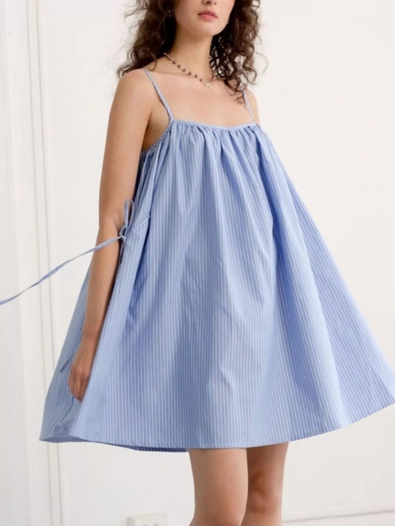 Polka dot spaghetti strap mini dress by Shopimist, featuring a flirty sleeveless design and playful dot pattern.
