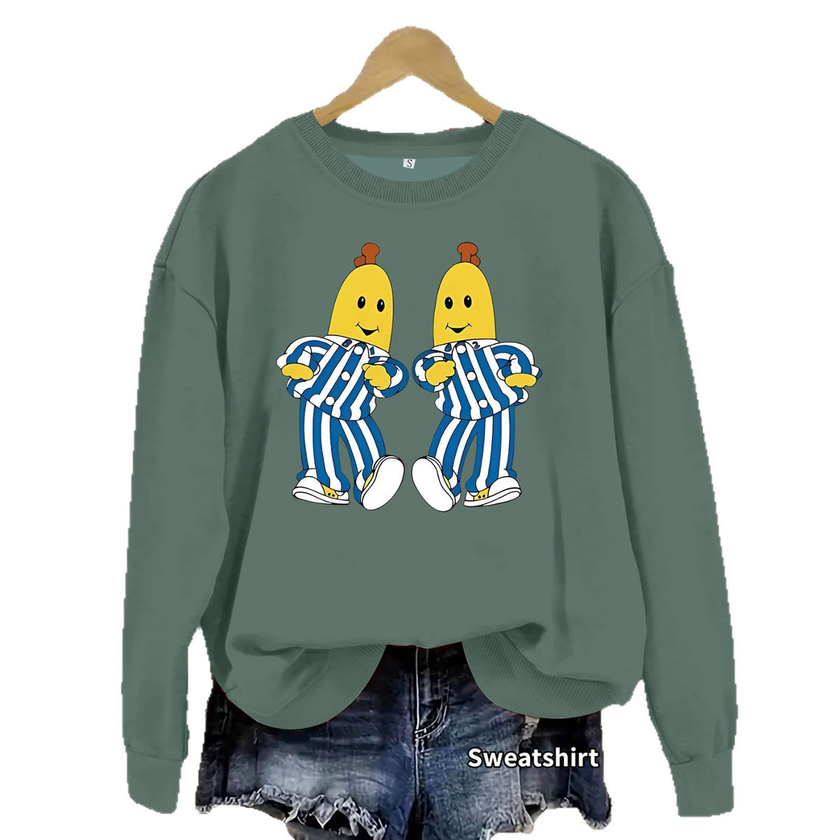 Olive green crewneck sweatshirt featuring a graphic of two bananas in blue and white striped pajamas.