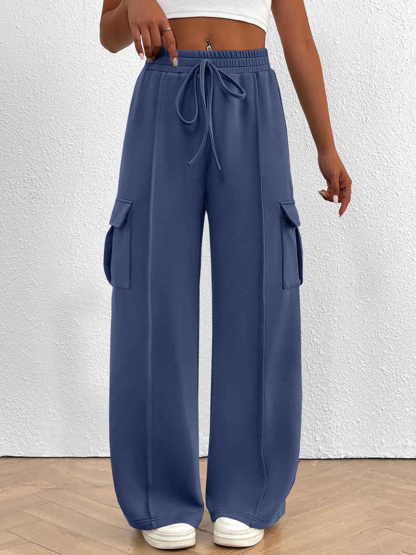 Women's high-waisted casual cargo pants with drawstring, lightweight utility style, featuring multiple pockets and a relaxed fit.