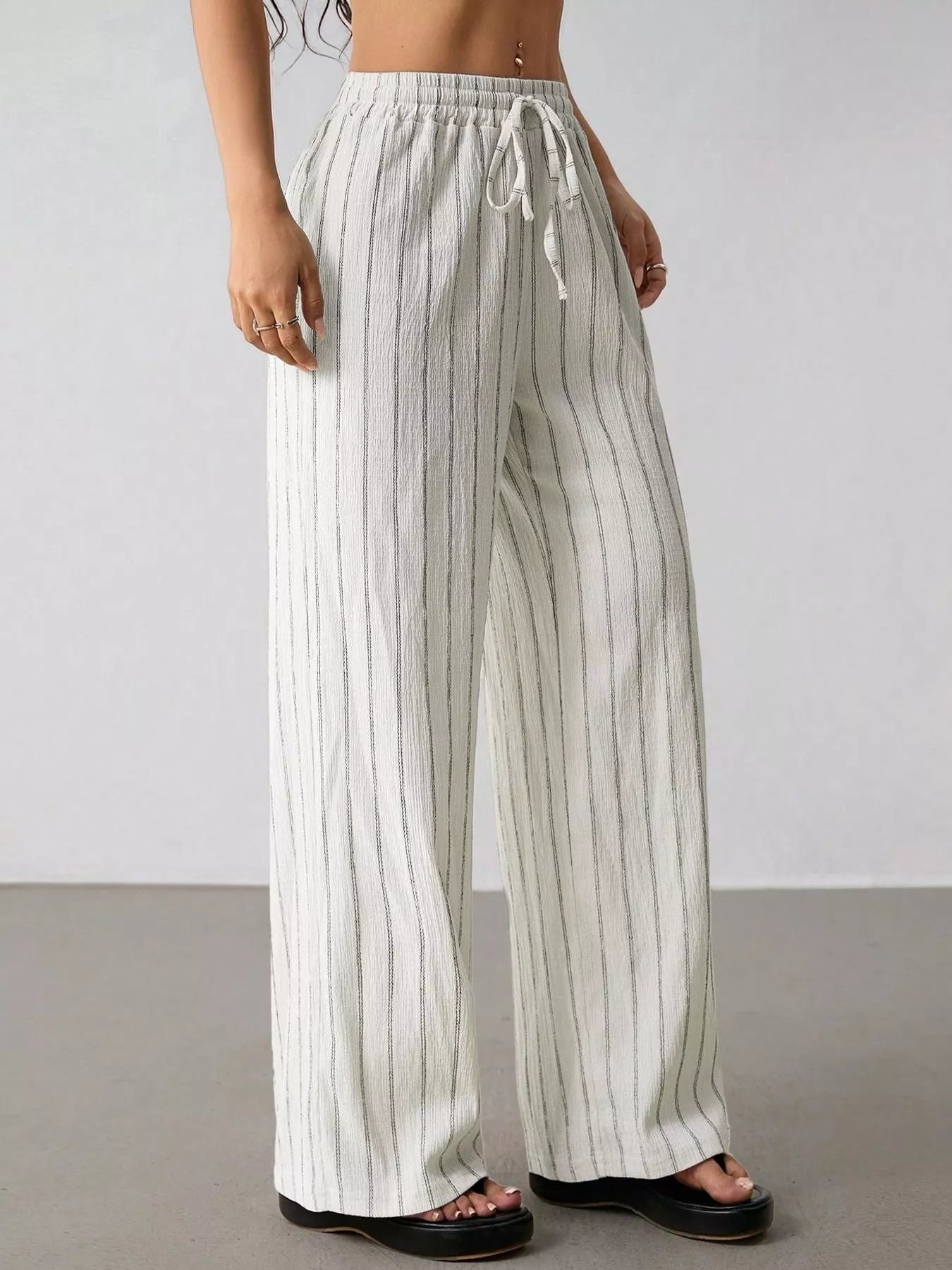 Plush Fashion Hub striped wide-leg drawstring pants with a relaxed fit and comfortable waistband, shown in black and white stripes.