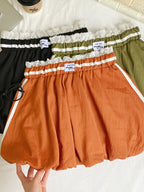 Lace trim elastic waist mini skirt from Trendsi featuring a stylish design and comfortable fit, shown in a flat lay view.